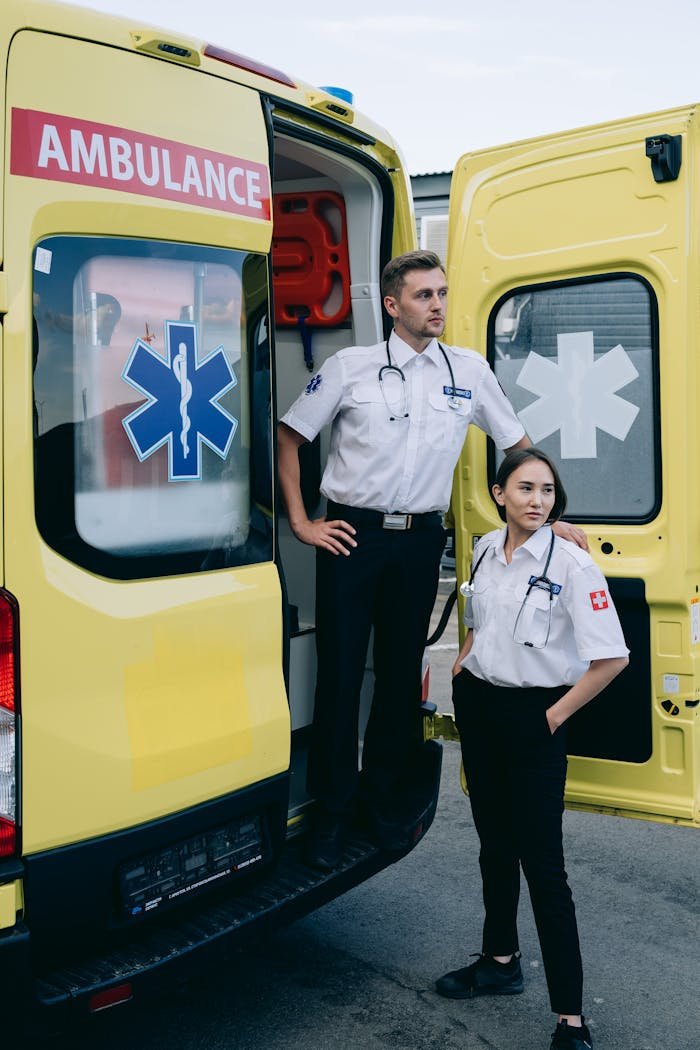 Professional paramedics standing next to an ambulance, ready to respond to emergencies.